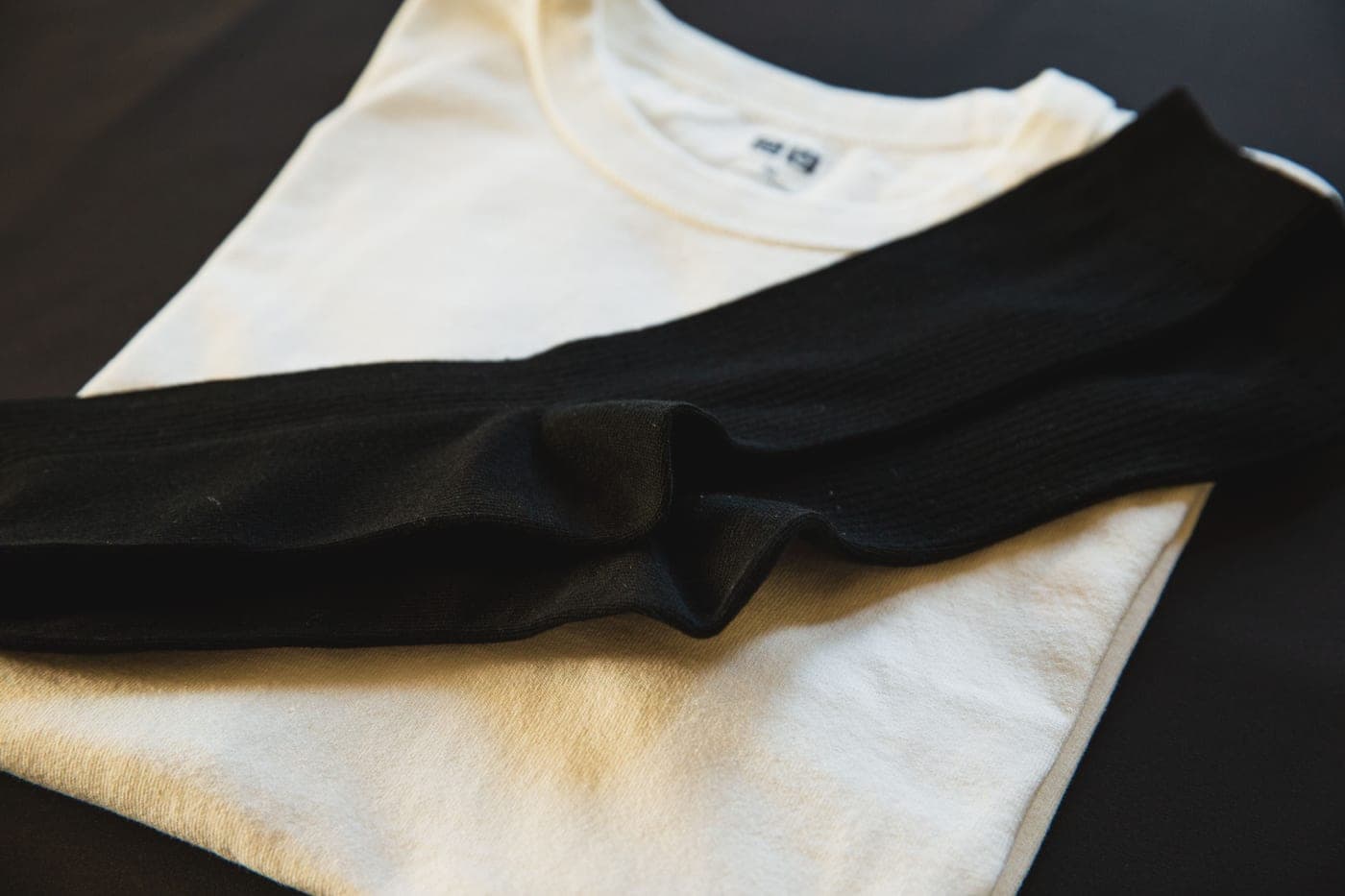 Overhead view of folded clothing and a pair of socks
