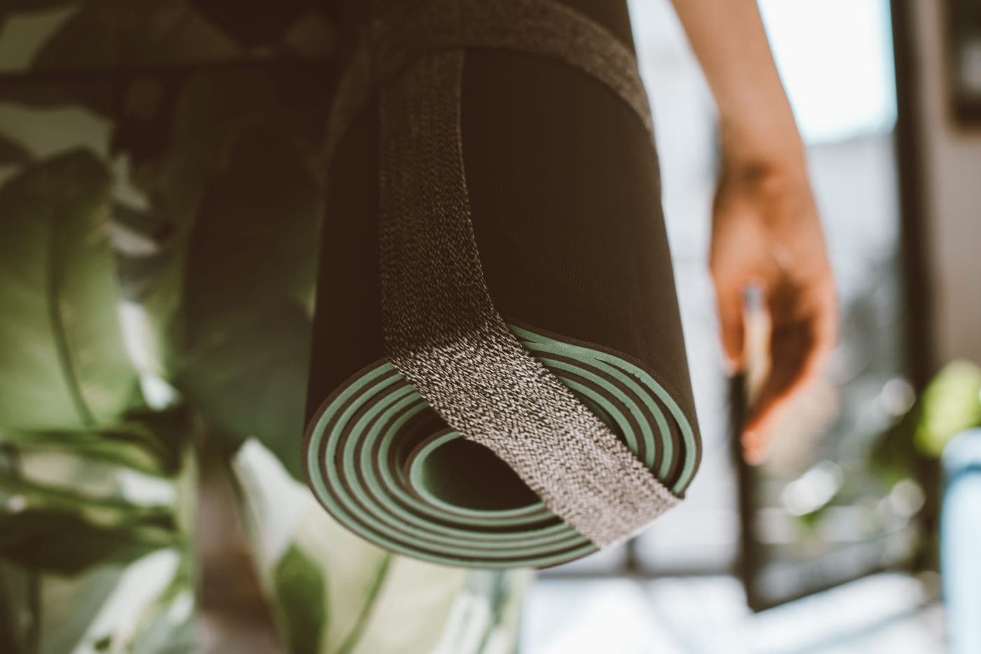 Close-up of a rolled mat held closed by a strap