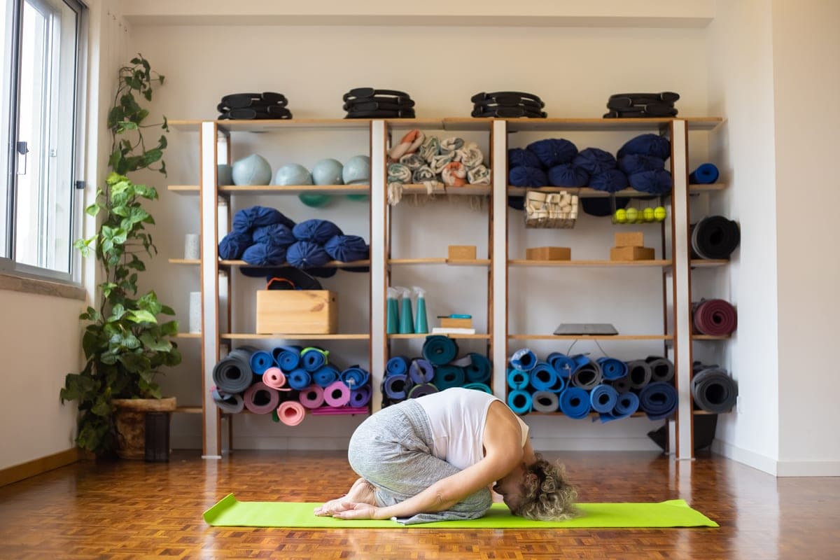 Stock photo: a studio floor with a mat surrounded by props in natural light