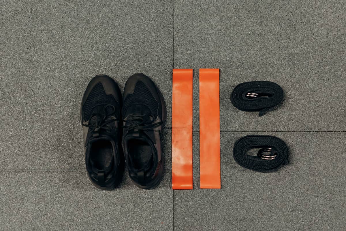 Stock photo: flat lay of resistance bands, straps and training shoes